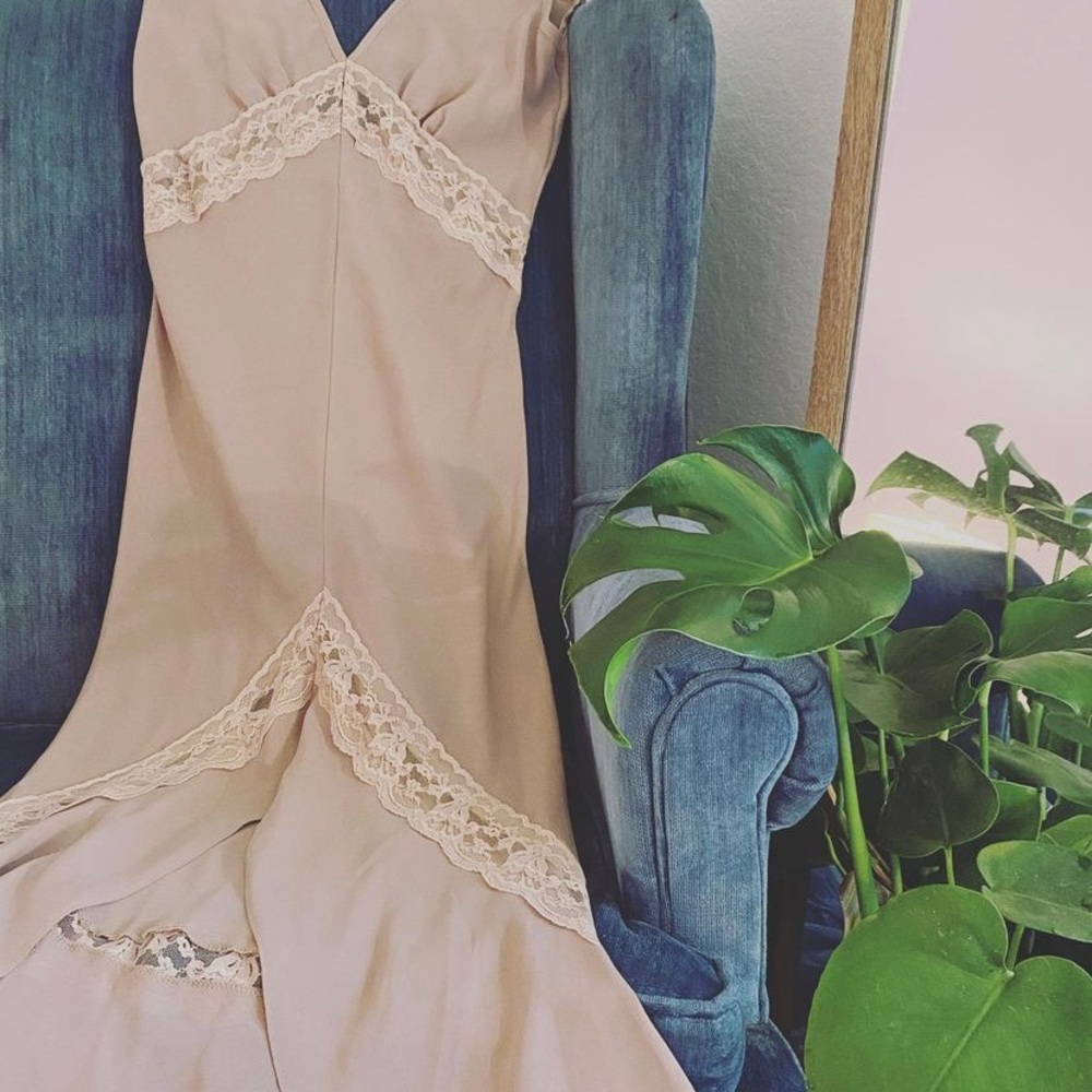 Creme colored lace sheer slip with a mermaid style flair and open back.